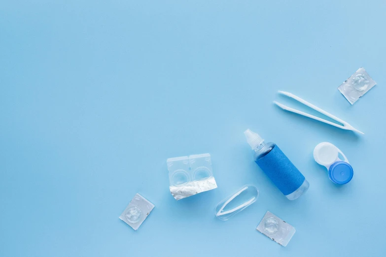 some surgical items are laying out on a blue table