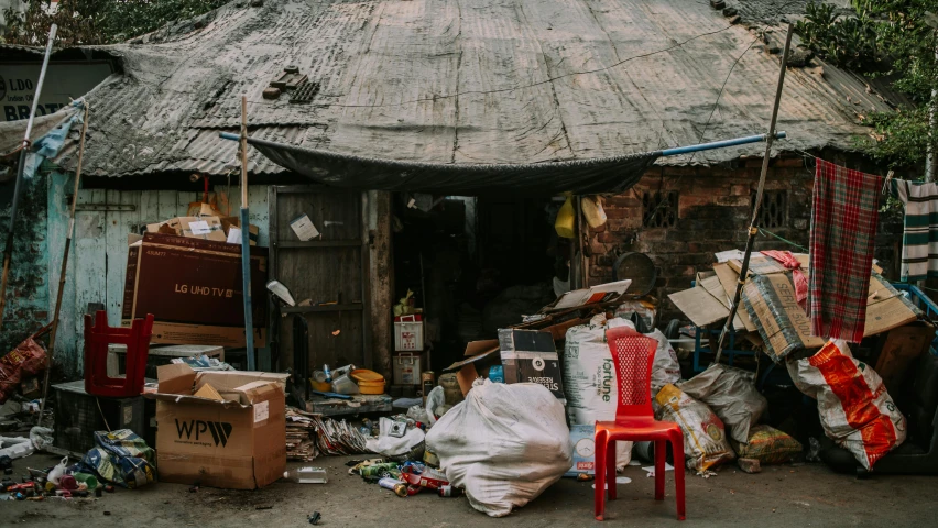 a house is outside with junk all around it