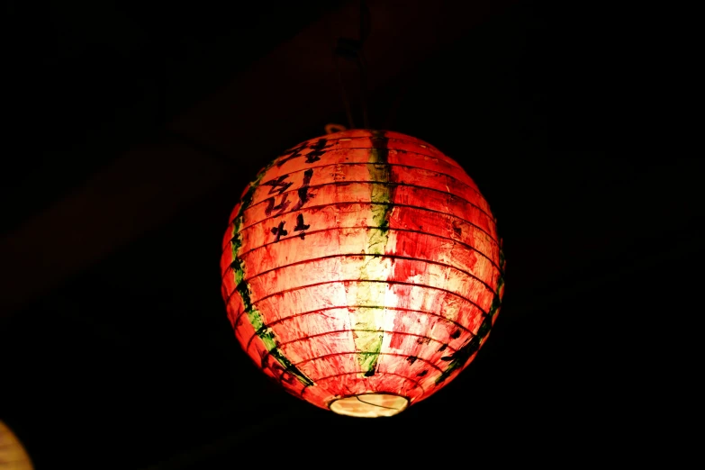 a chinese lantern is lit up in the dark