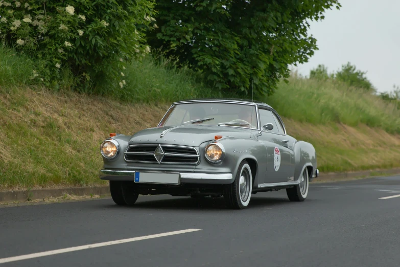 an old car on the road during the day