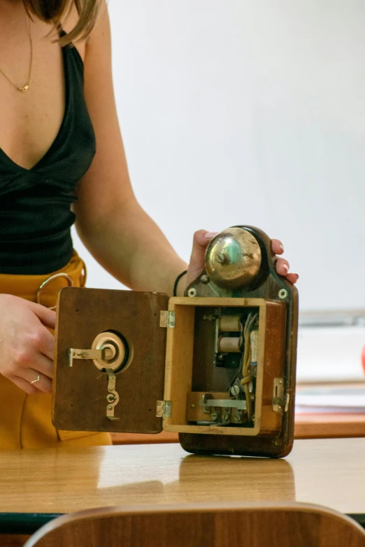 woman looking at an antique style wooden camera