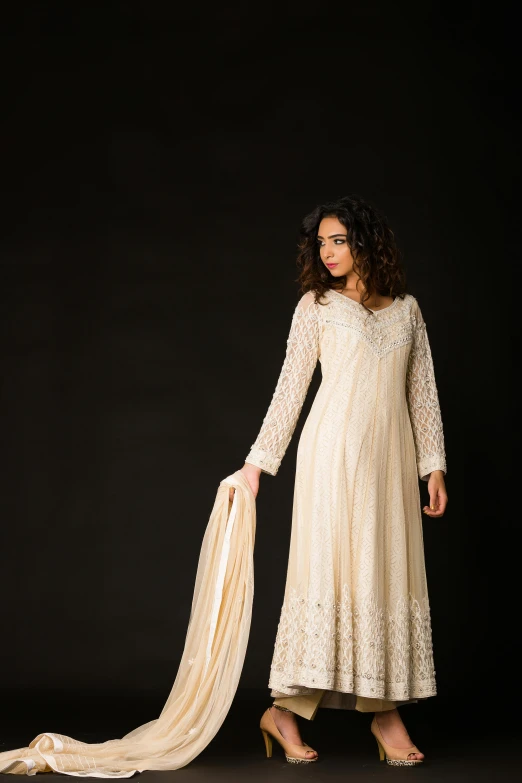 a woman in a white dress posing for the camera