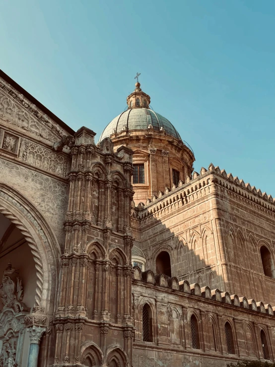 a large ornate structure with a domed top and a pointed rose - shaped tower