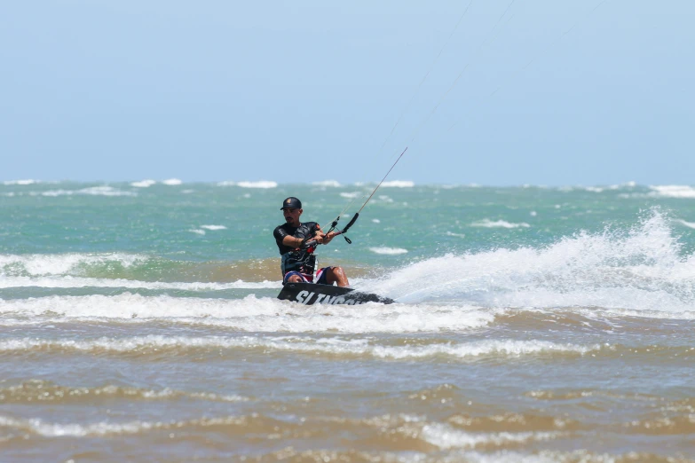 person using a boat that has a parachute while in the water