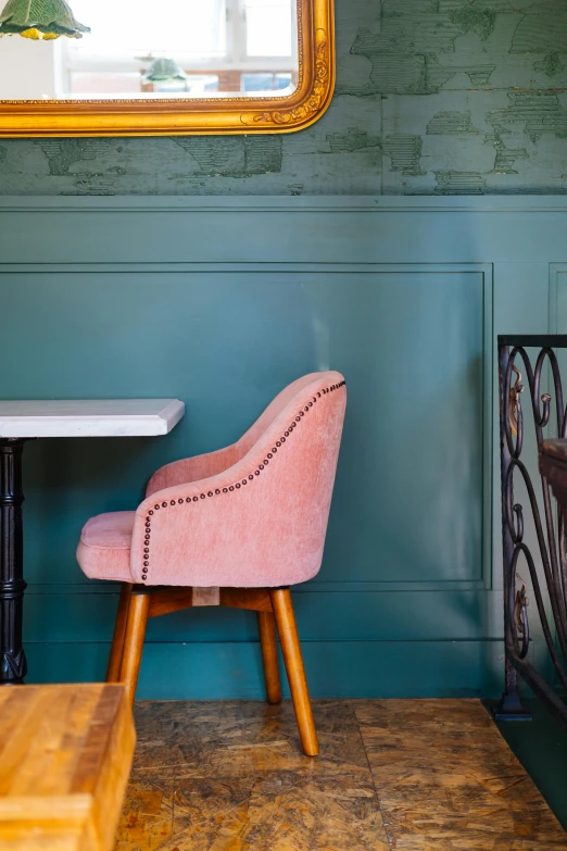 there is a small table with a small pink chair