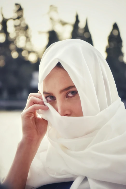 a woman with a white scarf around her neck