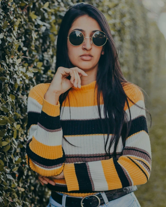 a beautiful young woman wearing a striped shirt