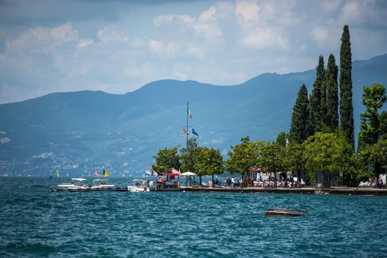 a boat sailing past mountains on the water