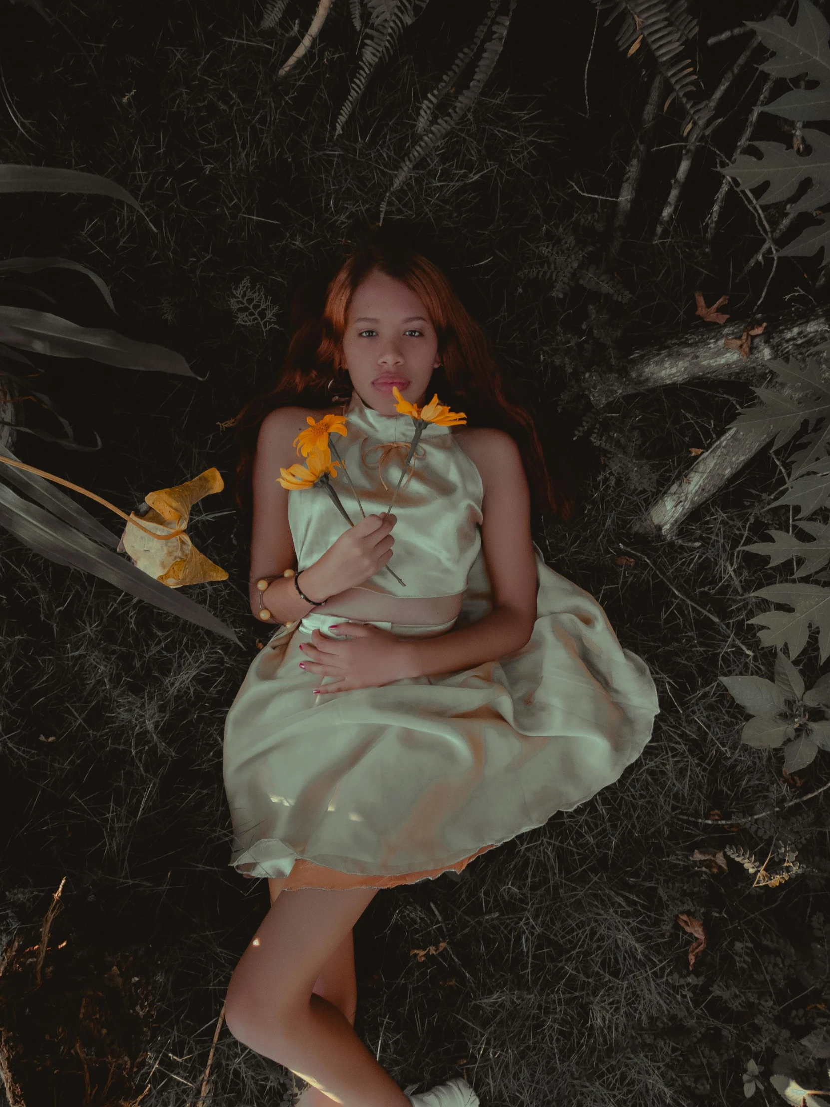 an image of a woman wearing a dress that is sitting in grass