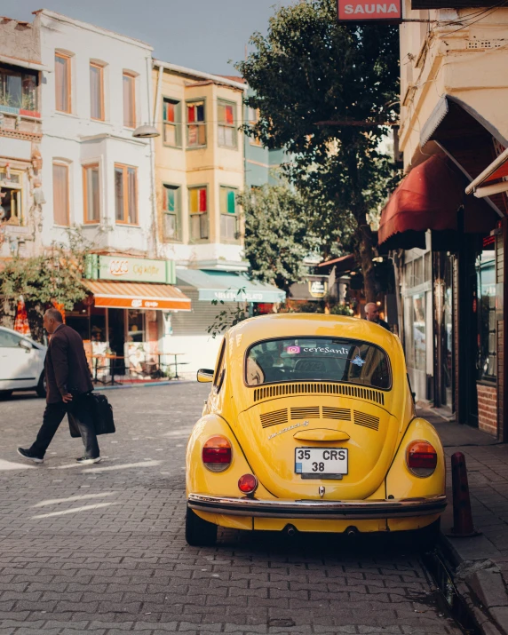 a yellow car parked on the side of the road