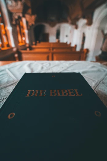 an old german bible sitting on the bed