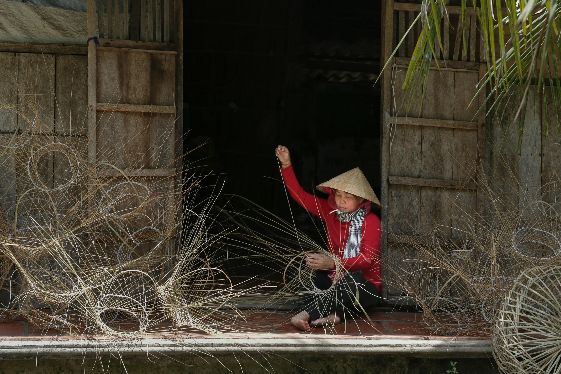 the woman is sitting in the doorway waving goodbye