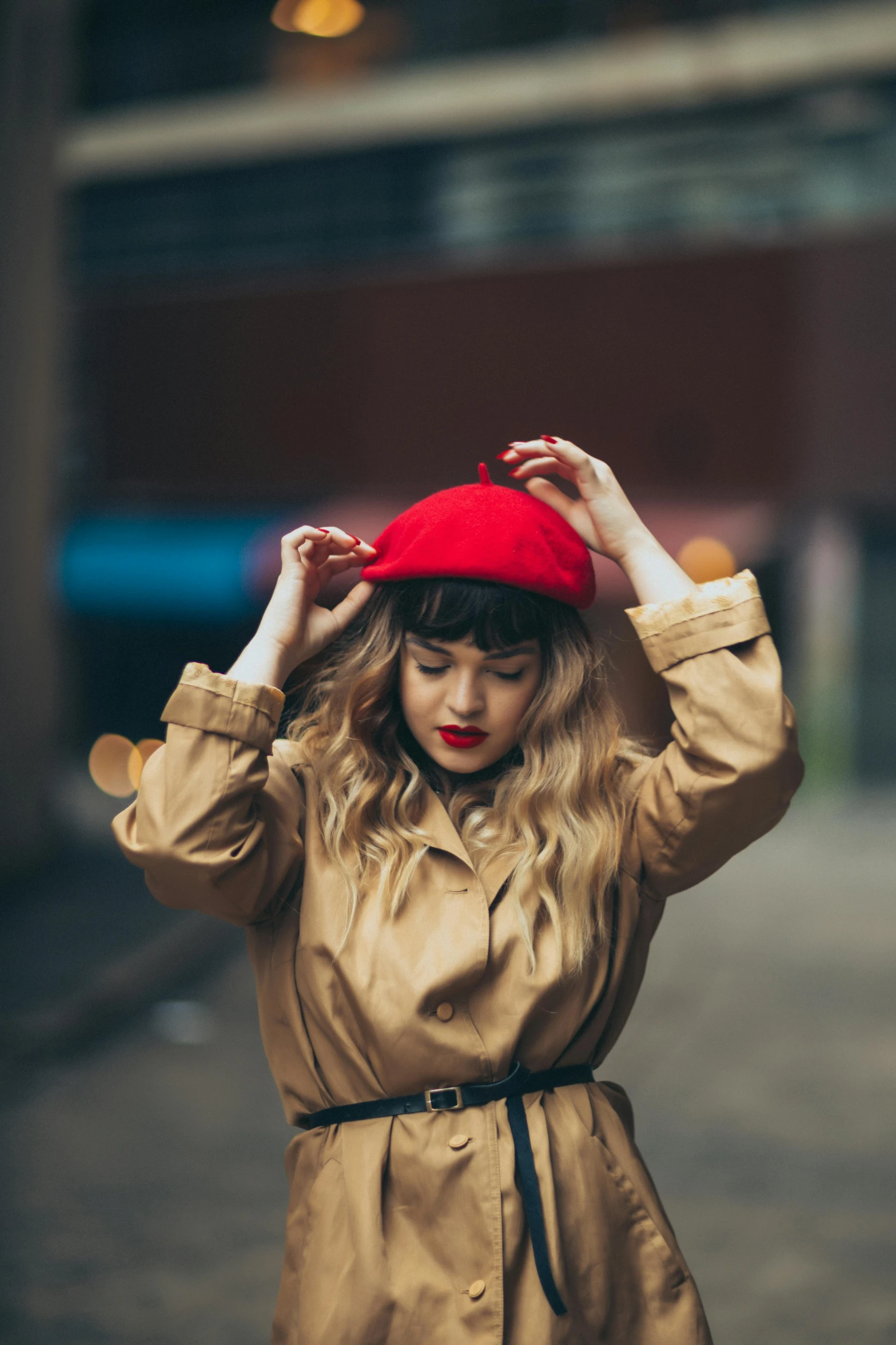 young woman in brown dress and hat walking down the street