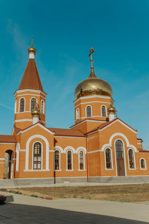 a large church has two golden domes on it