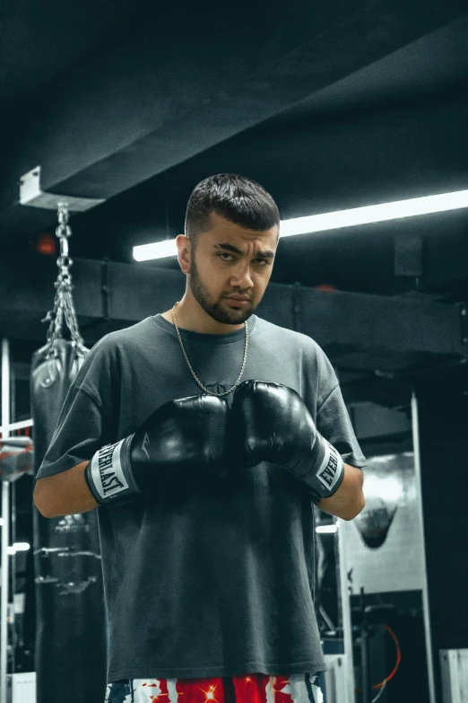 a young man wearing gloves in a gym