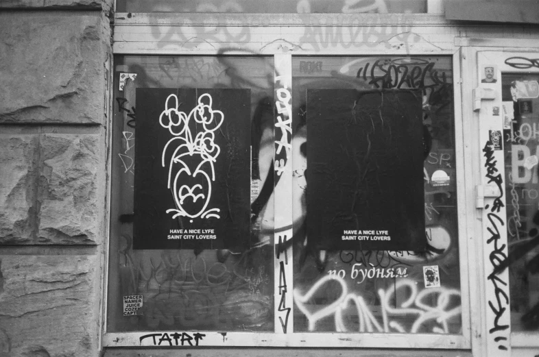 a window with graffiti written on it near a wall