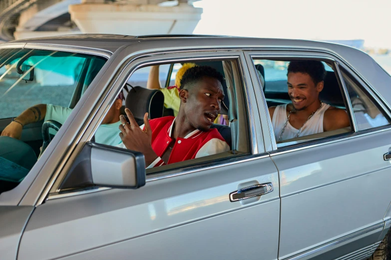 a man riding in the back seat of a car