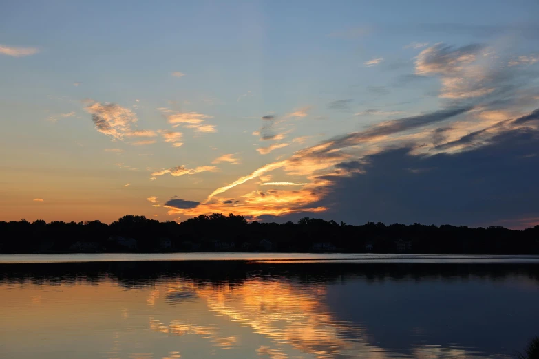 the sunsets are reflecting in the still waters