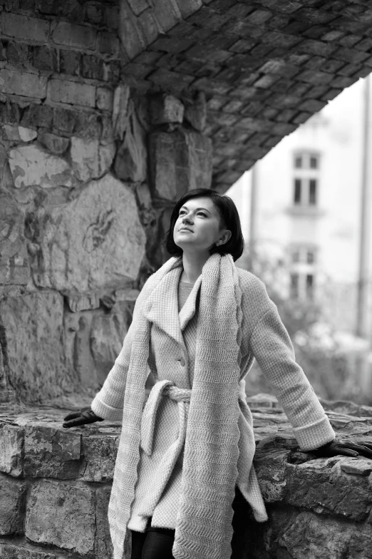 woman in fur coat posing for camera on bridge