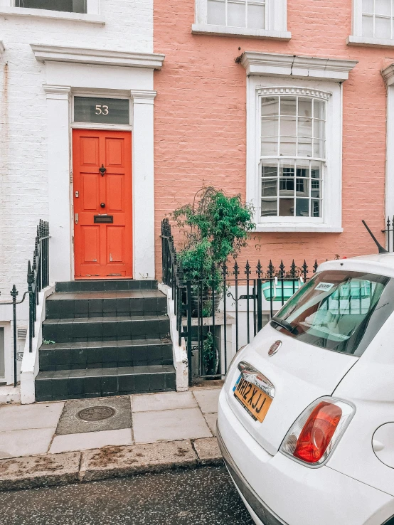 a car parked on the side of the street next to a building