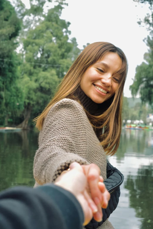 there is a young woman holding the hand of a woman