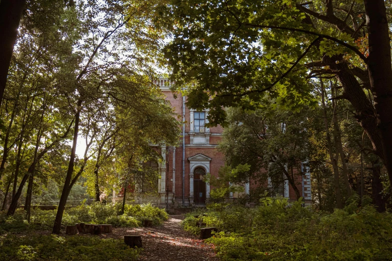 a large brick house surrounded by trees and shrubs