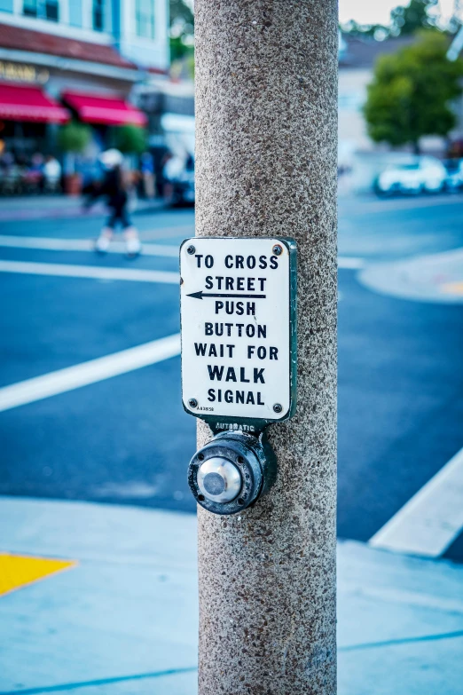 a street sign attached to the pole next to a sidewalk