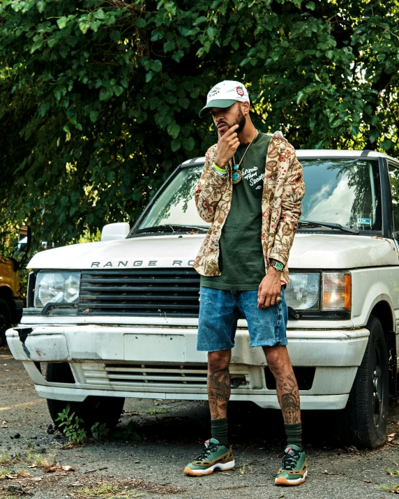 a man standing next to a car talking on a phone