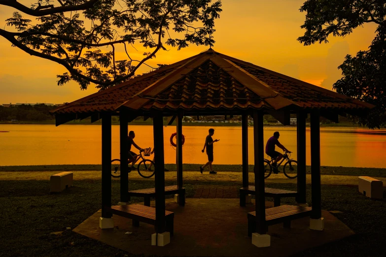 people are riding their bikes in an old gazebo