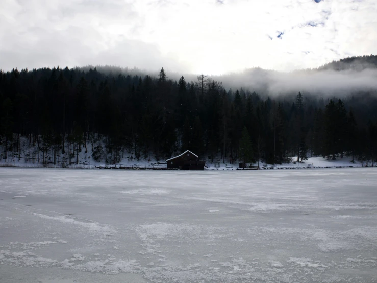 an image of snow in the foreground and fog in the distance