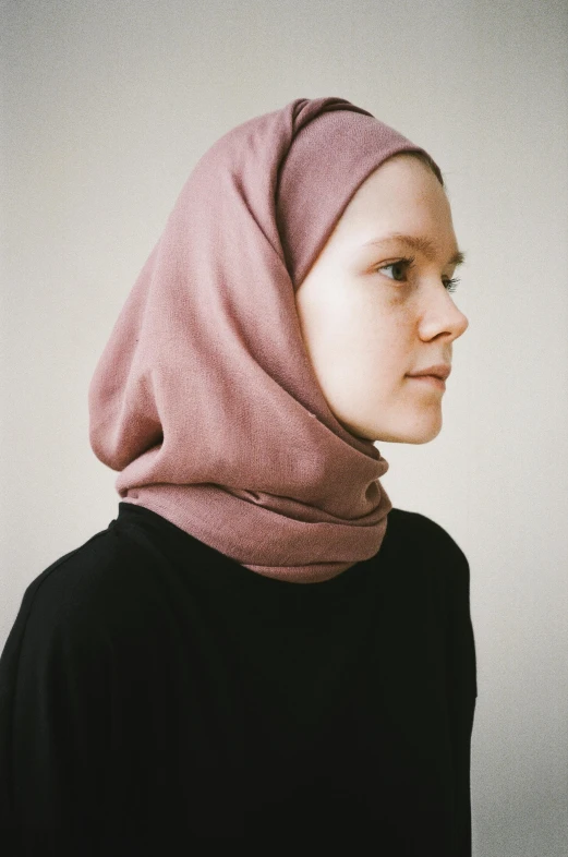 a woman in black shirt with a pink scarf on