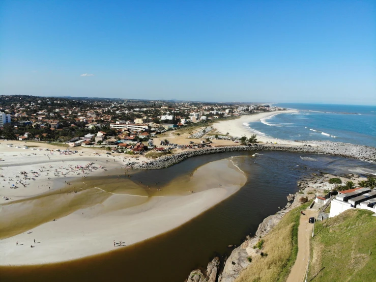 a river flowing into a city near a beach