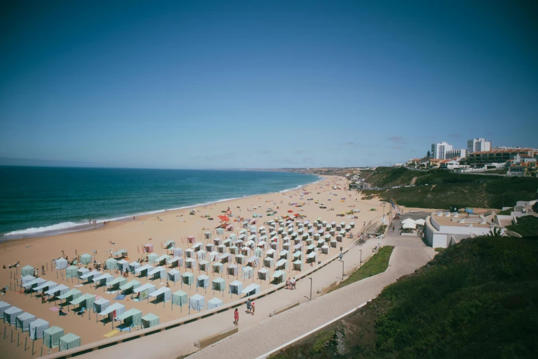 a beach with lots of chairs and umbrellas