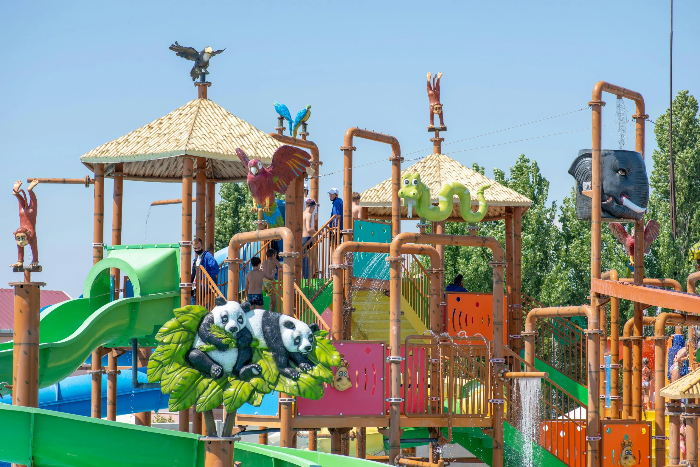 a colorful childrens play area and slides at a park