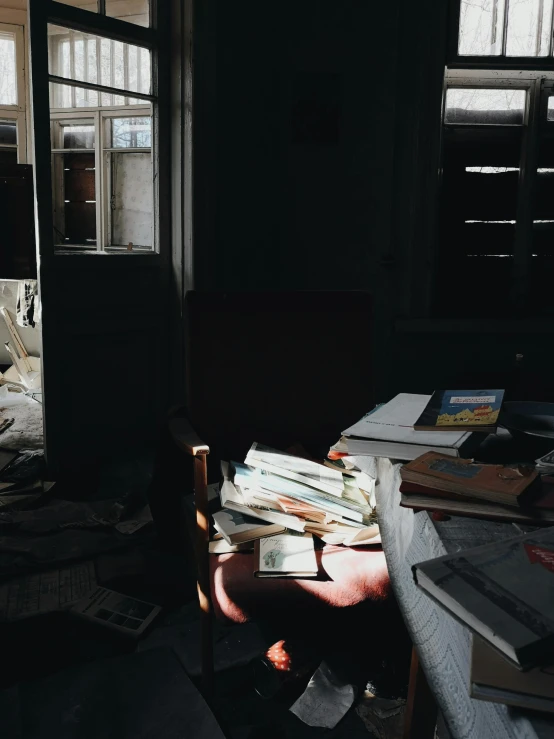 a room with some books on the floor and a chair in it