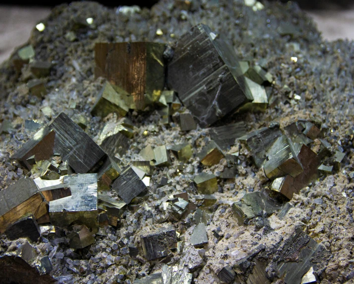 various chunks of silver and green glass litter on cement