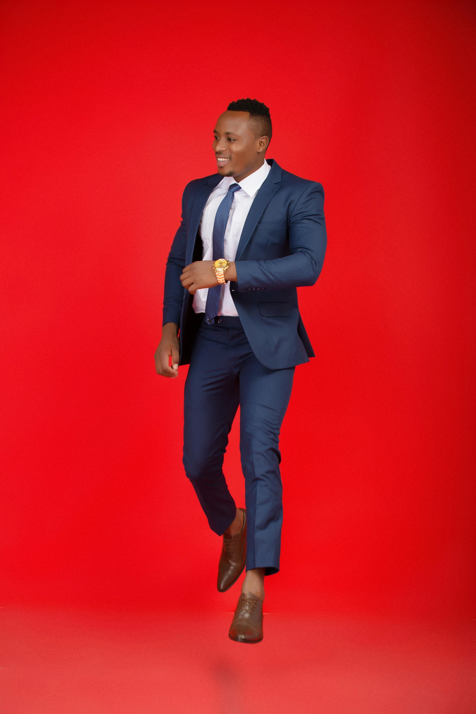 a young black man in a blue suit and tie