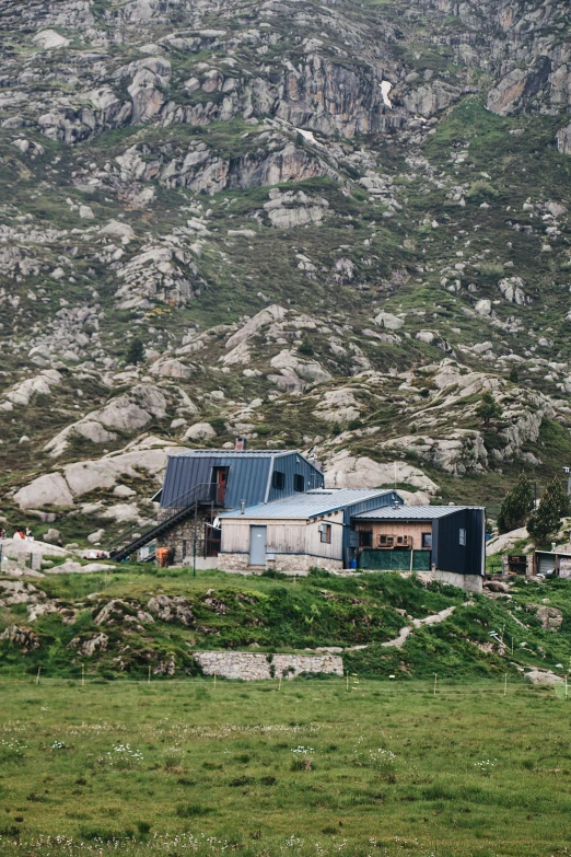 an old building sitting on top of a lush green hillside