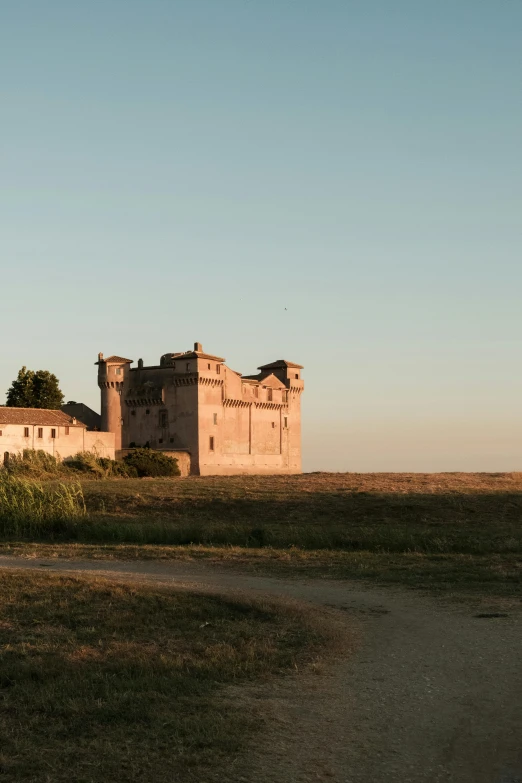 the old castle sits alone in the field