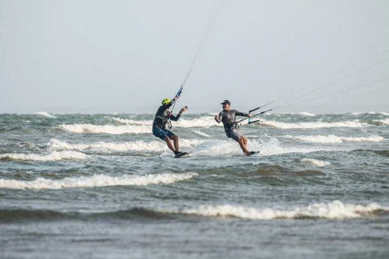 two people are kite surfing in the ocean