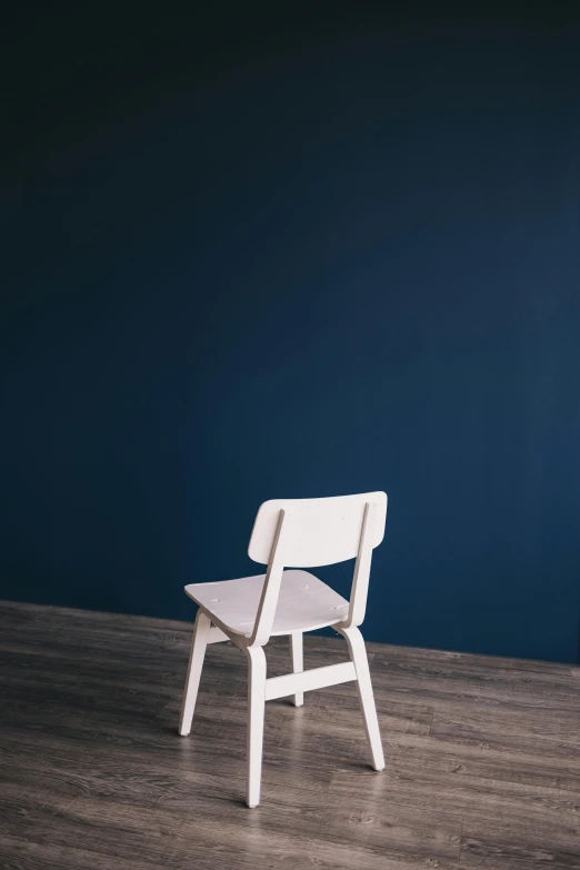 a wooden chair with a seat on the floor