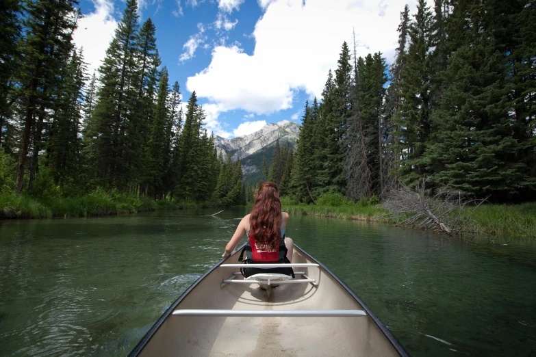 a person riding on the back of a boat in a lake