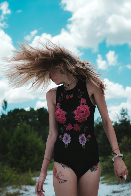 girl in a floral print swim suit with an upside down hair