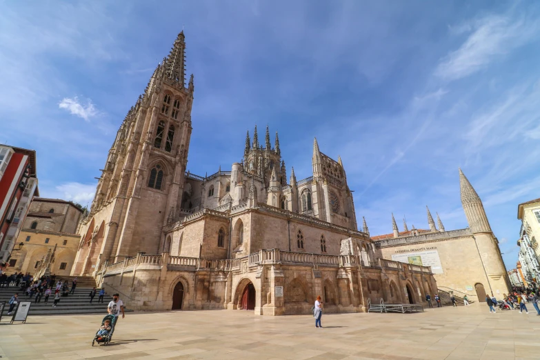 a tall cathedral with steeple rises above the surrounding buildings