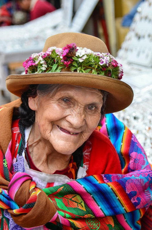 a woman wearing a hat with flowers on it