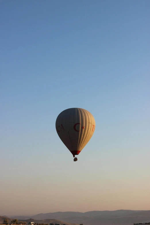 a large balloon is in the air with a sky background