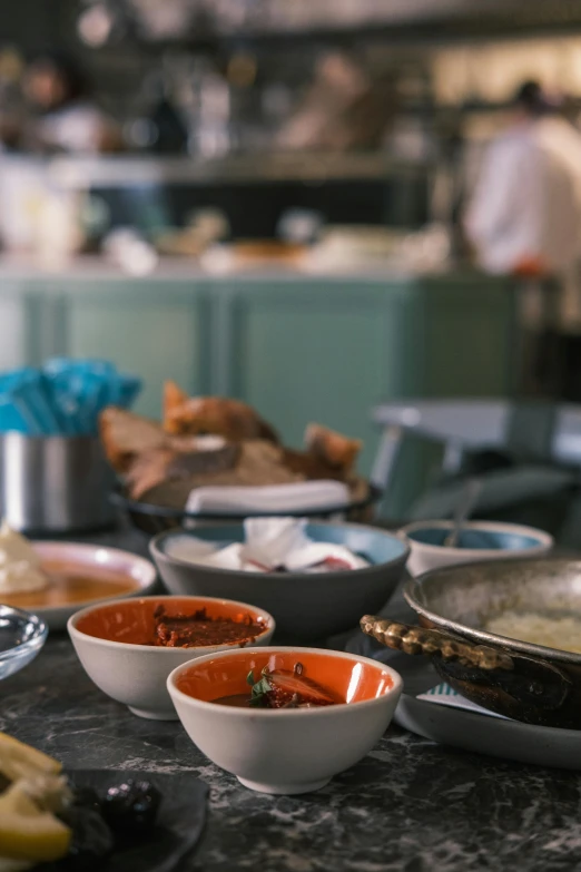 several different dishes on a table that include bananas, croutons and sauces