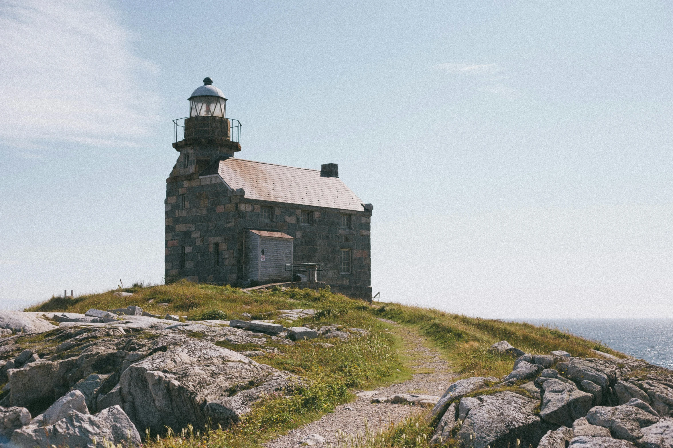 the small lighthouse has a white roof on it