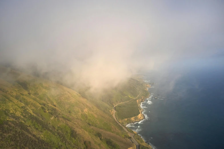 a scenic view from above of green hills overlooking the sea