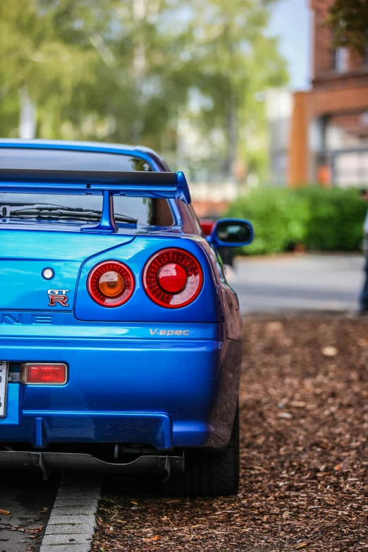 a blue convertible is parked in the street